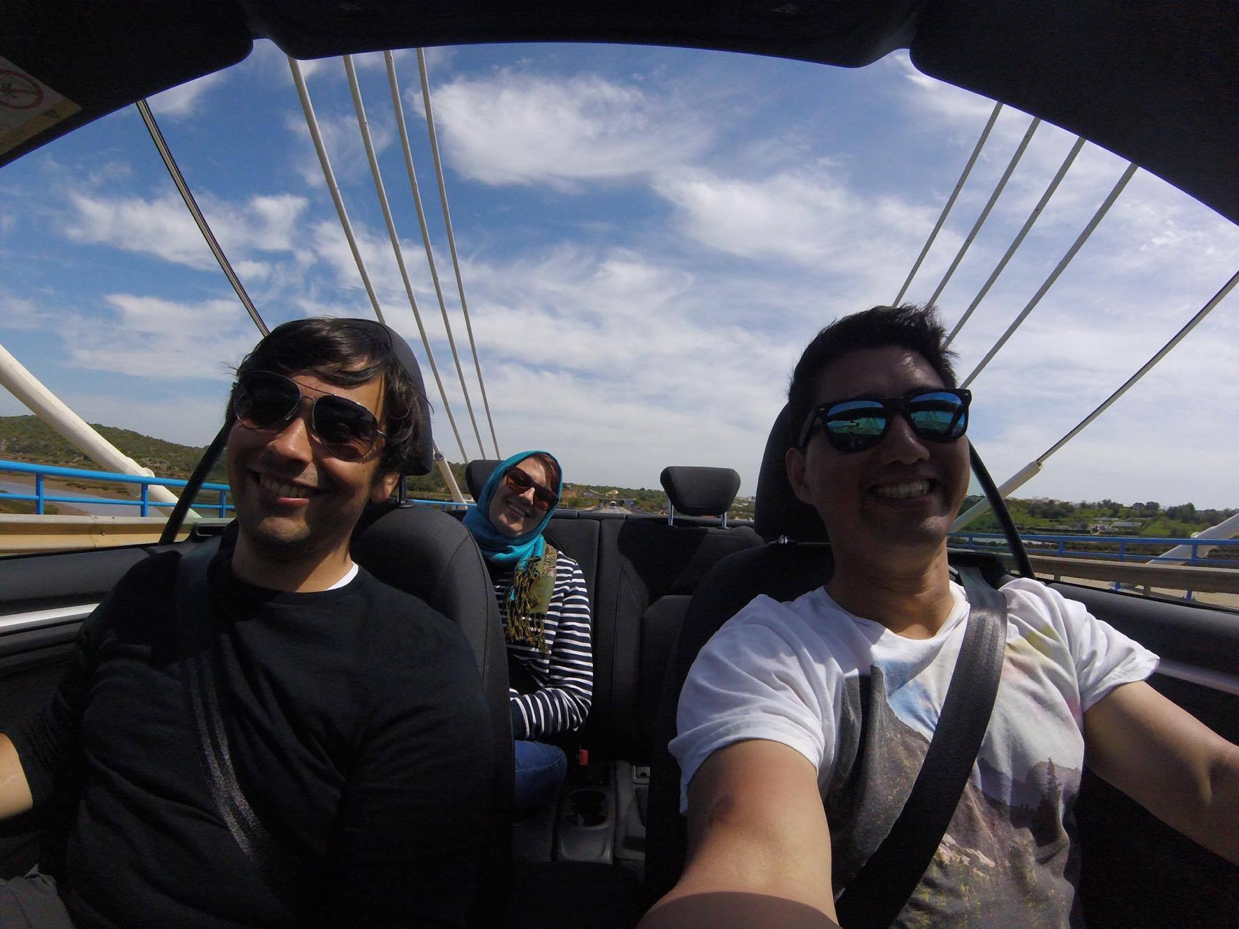 A picture of 3 friends in a convertible